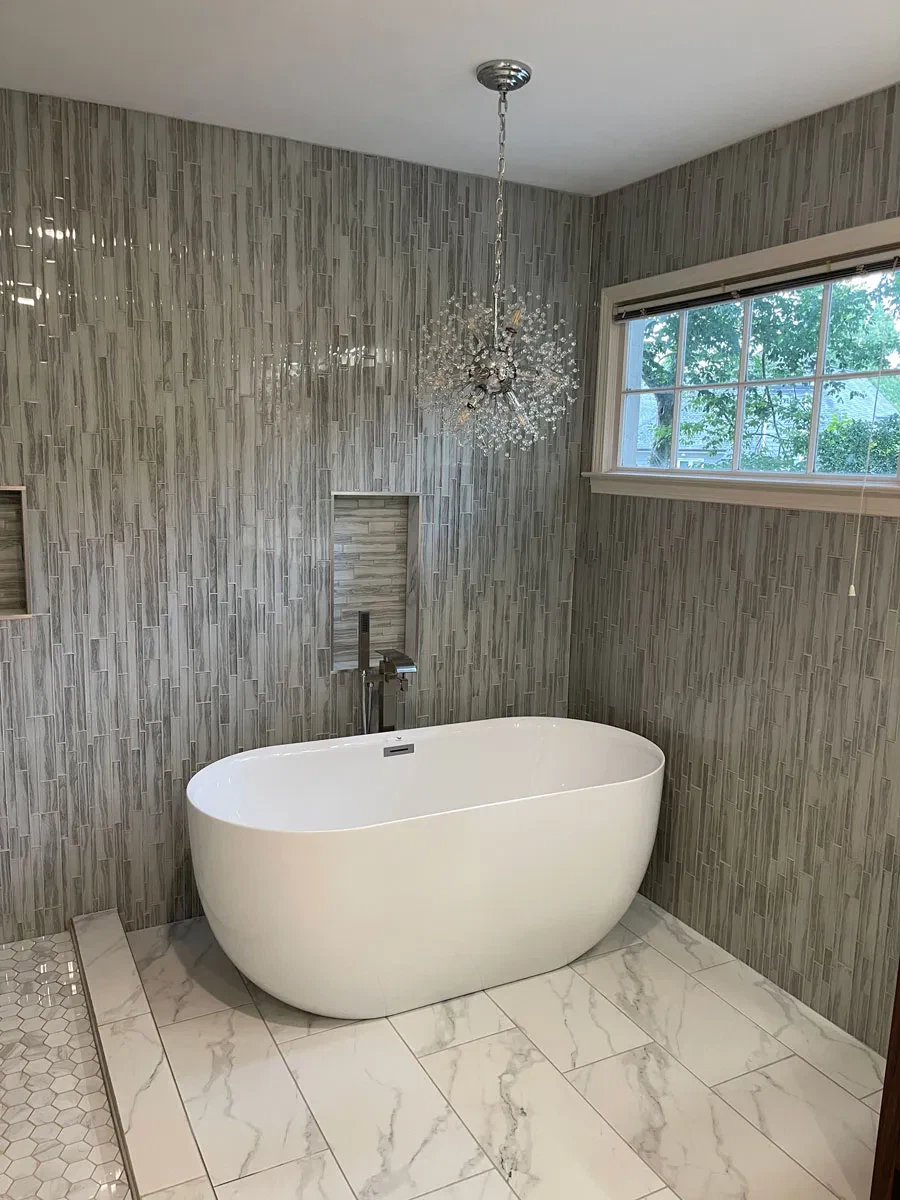 Elegant bathroom with freestanding tub and chandelier
